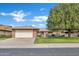 Charming single-story brick home with a well-manicured lawn and mature shade tree at 9606 W Shasta Dr, Sun City, AZ 85351