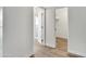 Hallway leading to a modern bathroom and closet, showcasing clean lines and minimalist design at 9606 W Shasta Dr, Sun City, AZ 85351