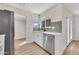 Bright kitchen features stainless appliances, white cabinets, and a modern backsplash at 9606 W Shasta Dr, Sun City, AZ 85351