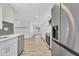 Modern kitchen showcasing stainless steel appliances, white cabinets, and open layout at 9606 W Shasta Dr, Sun City, AZ 85351