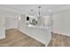 Bright and open floor plan featuring a kitchen with island and white cabinetry at 9606 W Shasta Dr, Sun City, AZ 85351