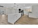 Open kitchen boasts a large island, stainless appliances, and updated cabinetry at 9606 W Shasta Dr, Sun City, AZ 85351