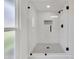 Modern shower with glass enclosure, white subway tile and stylish fixtures at 9606 W Shasta Dr, Sun City, AZ 85351