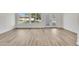 Bright sunroom featuring updated flooring and large windows at 9606 W Shasta Dr, Sun City, AZ 85351