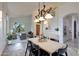 Bright dining area with high ceilings, modern lighting, and an adjacent living room at 9867 S 182Nd Dr, Goodyear, AZ 85338