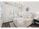 Bright bedroom features contemporary chandelier and natural light from white shuttered windows at 9921 E South Bend Dr, Scottsdale, AZ 85255