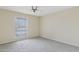 Bedroom with soft carpeting, a ceiling fan, and a window providing natural light at 10004 W Desert Forest Cir, Sun City, AZ 85351