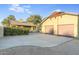 The garage is a two car garage with a wide driveway and lush bushes for added privacy to the property at 101 W Cypress St, Phoenix, AZ 85003