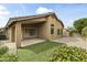 Backyard with manicured grass, covered patio, and privacy fencing at 10226 E Pine Valley Rd, Scottsdale, AZ 85255
