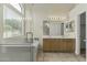 Bright bathroom featuring a double sink vanity, and a large window for natural light at 10226 E Pine Valley Rd, Scottsdale, AZ 85255