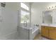 Bathroom featuring a glass enclosed shower and soaking tub at 10226 E Pine Valley Rd, Scottsdale, AZ 85255