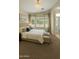 Serene bedroom featuring a plush bed, neutral color scheme, and an adjacent bathroom at 10226 E Pine Valley Rd, Scottsdale, AZ 85255