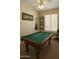 A fun game room featuring a classic pool table, game-themed décor, and a ceiling fan at 10226 E Pine Valley Rd, Scottsdale, AZ 85255