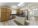 Well-lit kitchen features an island, stainless steel appliances, and granite countertops at 10226 E Pine Valley Rd, Scottsdale, AZ 85255