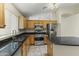 Well-lit kitchen features stainless steel appliances and black granite countertops at 10226 E Pine Valley Rd, Scottsdale, AZ 85255