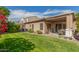 Back yard featuring lush grass, an AC unit, and a covered patio perfect for entertaining at 10359 E Jacob Ave, Mesa, AZ 85209