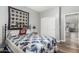 Bedroom features a large quilt, wood-look floors, closet, and neutral gray walls at 10359 E Jacob Ave, Mesa, AZ 85209
