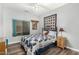A cozy bedroom featuring a quilt, light-colored walls, wood-look floors, and a window at 10359 E Jacob Ave, Mesa, AZ 85209