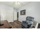 Bedroom featuring wood-look floors, closet, and a comfortable chair at 10359 E Jacob Ave, Mesa, AZ 85209