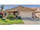 Inviting single-story home featuring a two-car garage, well-manicured lawn, and desert landscaping at 10359 E Jacob Ave, Mesa, AZ 85209