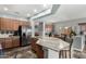 Bright, open kitchen with granite countertops, stainless steel appliances, and breakfast bar at 10359 E Jacob Ave, Mesa, AZ 85209