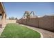 Fenced backyard featuring synthetic grass at 10859 E Thatcher Ave, Mesa, AZ 85212