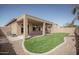 Backyard featuring a covered patio and artificial turf at 10859 E Thatcher Ave, Mesa, AZ 85212