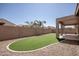 Private backyard with low-maintenance turf, framed by desert landscaping and brick wall at 10859 E Thatcher Ave, Mesa, AZ 85212