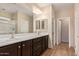 Bathroom featuring double sink vanity, large mirror, and a shower/tub combo at 10859 E Thatcher Ave, Mesa, AZ 85212