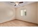 Bedroom with ceiling fan and a view to the neighborhood at 10859 E Thatcher Ave, Mesa, AZ 85212