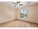 Bedroom with ceiling fan and a view to the neighborhood at 10859 E Thatcher Ave, Mesa, AZ 85212