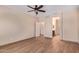 Bright bedroom featuring neutral walls, wood-look floors, ceiling fan, and trim detail at 10859 E Thatcher Ave, Mesa, AZ 85212