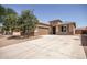 Single-story home with a wide driveway, two-car garage, and desert landscaping in front at 10859 E Thatcher Ave, Mesa, AZ 85212