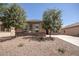 Charming single-story home featuring desert landscaping and stone accents on the facade at 10859 E Thatcher Ave, Mesa, AZ 85212