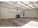 Spacious garage with overhead storage and a water heater at 10859 E Thatcher Ave, Mesa, AZ 85212