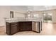The open-concept kitchen has stainless appliances, granite counters and a sink at 10859 E Thatcher Ave, Mesa, AZ 85212