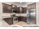 Gourmet kitchen with stainless appliances, granite countertops and dark wood cabinets at 10859 E Thatcher Ave, Mesa, AZ 85212