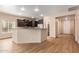 Kitchen featuring dark cabinetry, an island with seating, and wood-look tile flooring at 10859 E Thatcher Ave, Mesa, AZ 85212