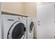 Bright laundry room featuring a full-size, front-loading washer and dryer set at 10859 E Thatcher Ave, Mesa, AZ 85212