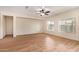 Bright living room featuring wood-look tile flooring, natural light, and a ceiling fan at 10859 E Thatcher Ave, Mesa, AZ 85212