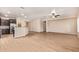 Spacious living room featuring light wood-look tile floors and modern ceiling fan at 10859 E Thatcher Ave, Mesa, AZ 85212