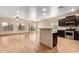Open living area with a kitchen island, wood-look tile flooring, and a ceiling fan at 10859 E Thatcher Ave, Mesa, AZ 85212