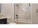 Modern bathroom features a tub with marble-patterned tile surround and black hardware at 11612 S 211Th Ln, Buckeye, AZ 85326