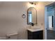 Modern half-bathroom with a sleek vanity and arch mirror at 11612 S 211Th Ln, Buckeye, AZ 85326