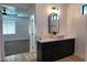 Bright bathroom featuring modern vanity, vessel sink, and an arch mirror at 11612 S 211Th Ln, Buckeye, AZ 85326