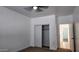 Neutral bedroom featuring carpeting, closet with sliding doors, and hallway access at 11612 S 211Th Ln, Buckeye, AZ 85326