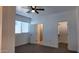 Bedroom with ensuite bath and walk-in closet, carpeted floor, and ceiling fan at 11612 S 211Th Ln, Buckeye, AZ 85326