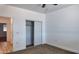 Bedroom with neutral carpeting, closet with sliding doors, and hallway access at 11612 S 211Th Ln, Buckeye, AZ 85326