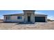 New construction features decorative stone accents at entry and garage with blue sky at 11612 S 211Th Ln, Buckeye, AZ 85326