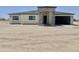 Charming single-Gathering home showcasing stone accents, black garage door, and manicured front yard at 11612 S 211Th Ln, Buckeye, AZ 85326